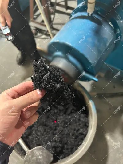 Sticky Carbon Prepreg → ~10 mm Short Fiber — Acceptance Trial project case image, Acceptance trial case study: sticky carbon fiber prepreg waste processed on the ZFS-250 into ~10 mm short fibers via low-speed fiber opening. Demonstrates how the process handles resin-impregnated, tacky carbon fiber scrap.